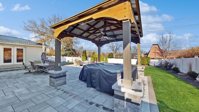 view of patio / terrace with grilling area, a gazebo, ceiling fan, and french doors