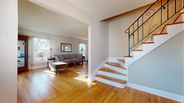 staircase featuring a healthy amount of sunlight and hardwood / wood-style floors