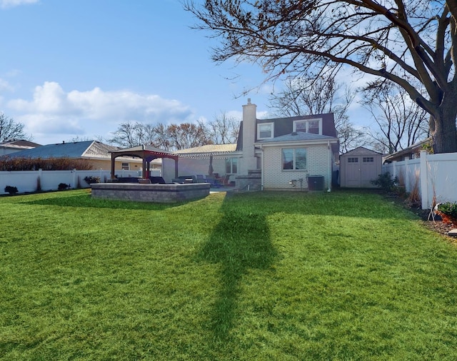 back of house featuring a yard, a gazebo, and a storage unit