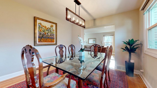 dining area with an inviting chandelier and hardwood / wood-style floors