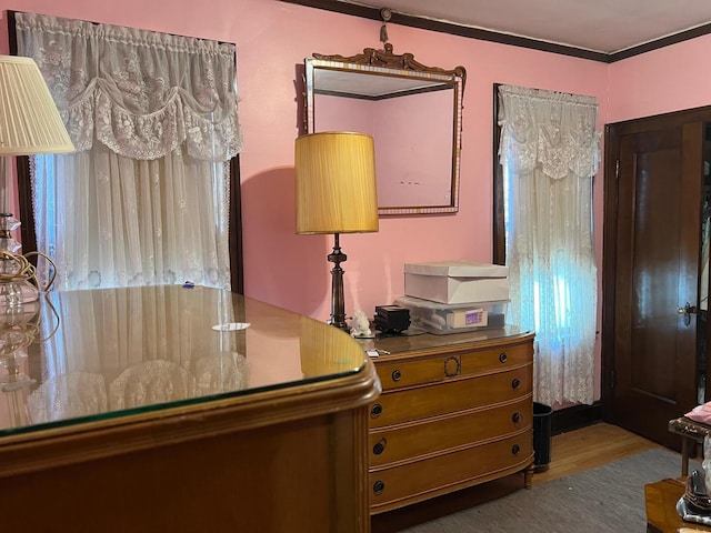 bedroom featuring hardwood / wood-style flooring and ornamental molding