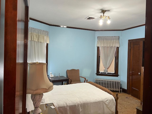 bedroom featuring crown molding and radiator