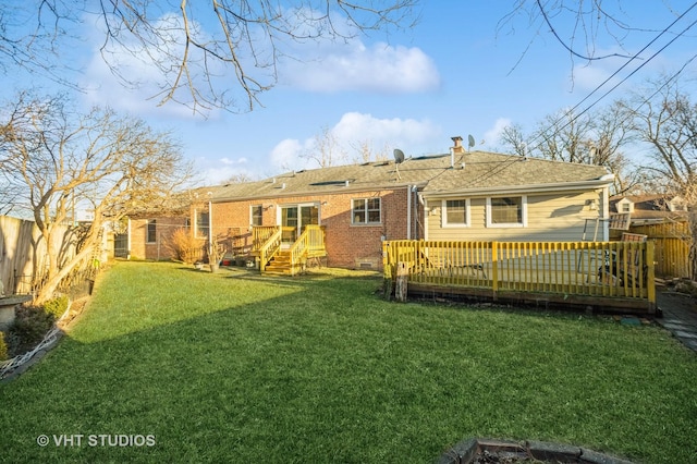 back of house featuring brick siding, a fenced backyard, and a wooden deck