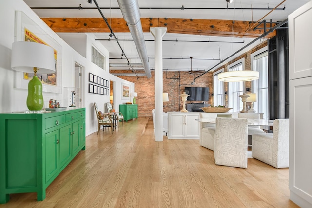 kitchen with white cabinets, light hardwood / wood-style flooring, brick wall, and green cabinets