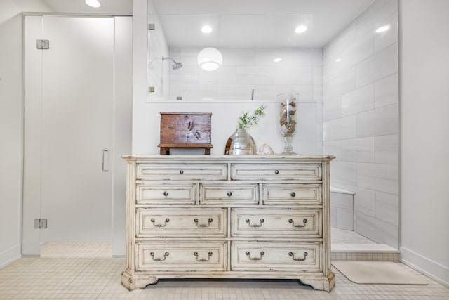 bathroom featuring tile patterned floors and a shower with door