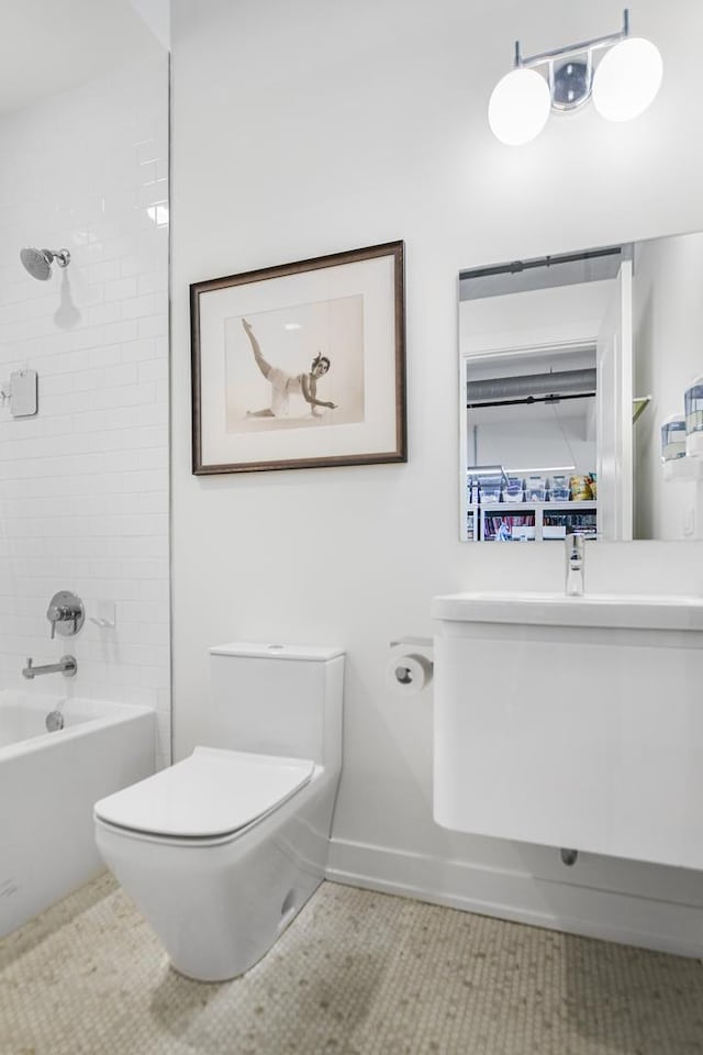 full bathroom with tile patterned flooring, tiled shower / bath, sink, and toilet