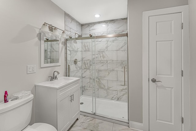 bathroom featuring vanity, toilet, and a shower with shower door