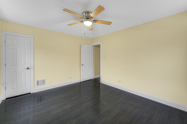 spare room with ceiling fan and dark hardwood / wood-style flooring