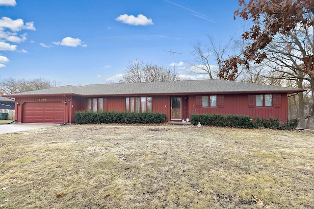 ranch-style house with a garage and a front lawn