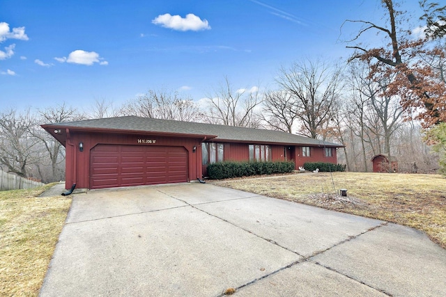 ranch-style home with a garage and a front lawn