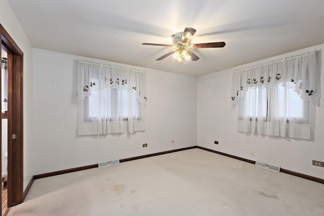 empty room with ceiling fan and carpet flooring