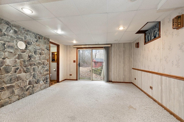 carpeted empty room with a drop ceiling