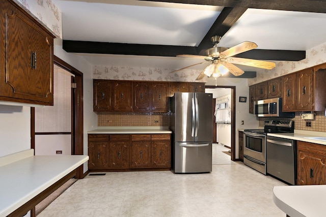 kitchen with ceiling fan, appliances with stainless steel finishes, beam ceiling, and dark brown cabinets