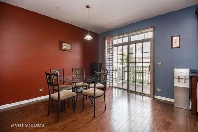 dining space with dark hardwood / wood-style floors