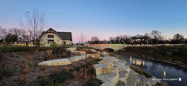 yard at dusk with a gazebo