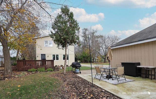 view of yard featuring a deck and a patio