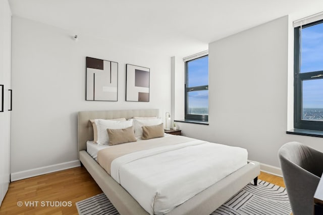 bedroom featuring wood-type flooring and multiple windows