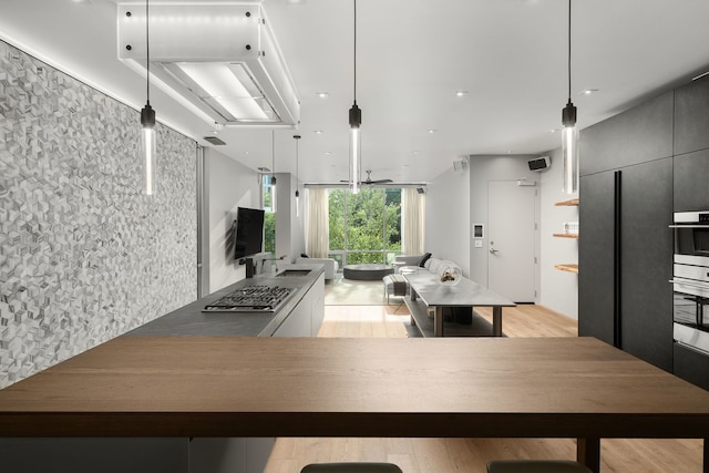 kitchen featuring hanging light fixtures and light wood-type flooring