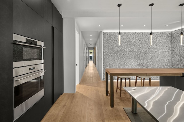 kitchen with hanging light fixtures and light hardwood / wood-style floors