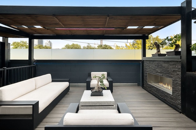 wooden deck featuring an outdoor living space with a fireplace