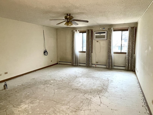 unfurnished room with a wall mounted AC, a wealth of natural light, a textured ceiling, and ceiling fan