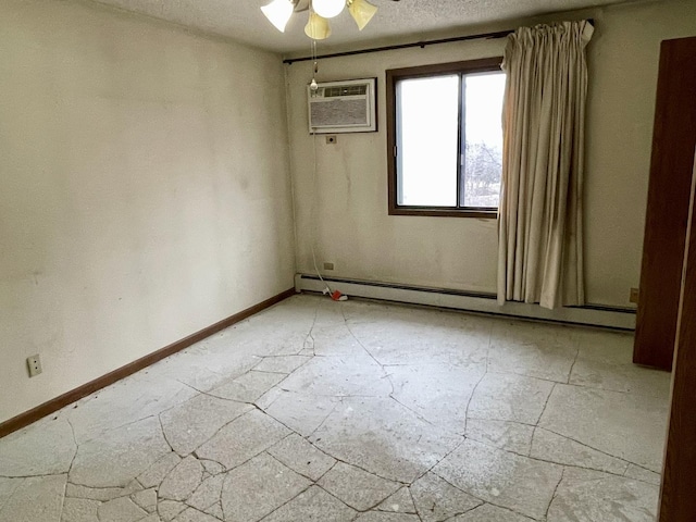 unfurnished room with ceiling fan, a baseboard radiator, a wall mounted air conditioner, and a textured ceiling