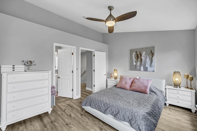 bedroom featuring ceiling fan, vaulted ceiling, and light hardwood / wood-style flooring