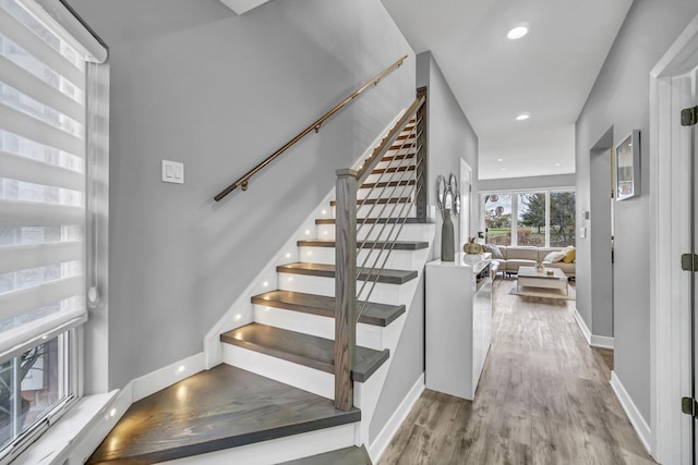 staircase featuring wood-type flooring