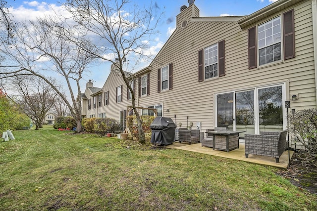 rear view of property featuring an outdoor living space, a patio area, and a lawn