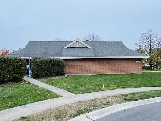 view of side of property with a lawn