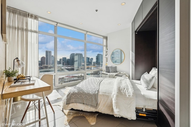 bedroom featuring tile patterned flooring and a wall of windows