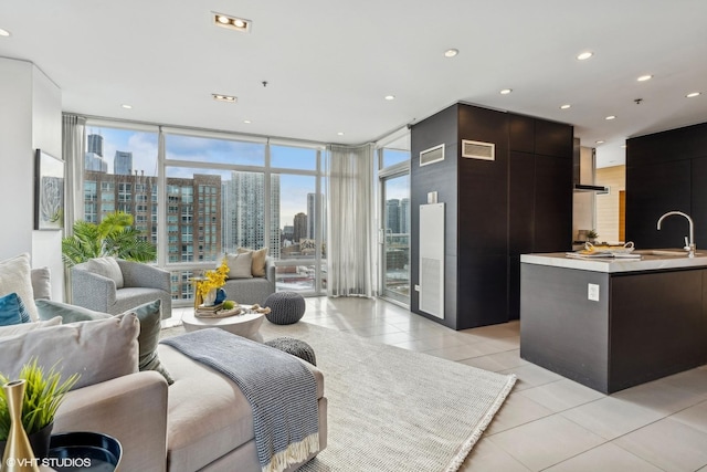 living room featuring floor to ceiling windows, sink, and light tile patterned floors