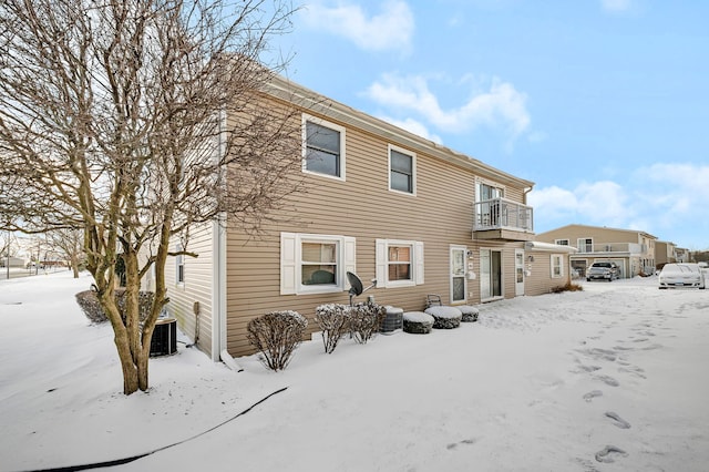 view of snow covered back of property