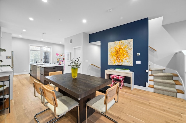 dining area featuring sink and light hardwood / wood-style flooring