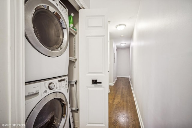 laundry area with stacked washer and clothes dryer and dark hardwood / wood-style floors