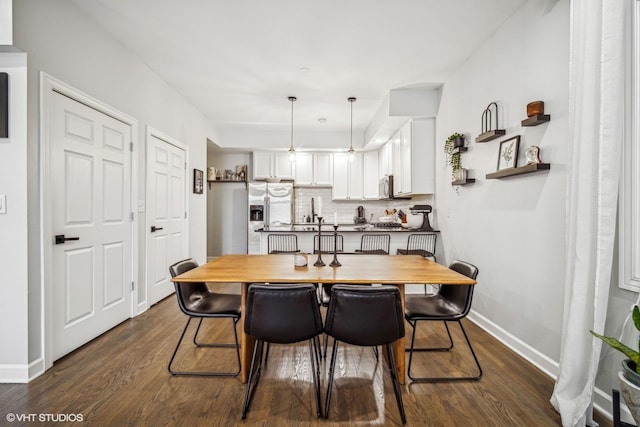 dining room with dark hardwood / wood-style floors