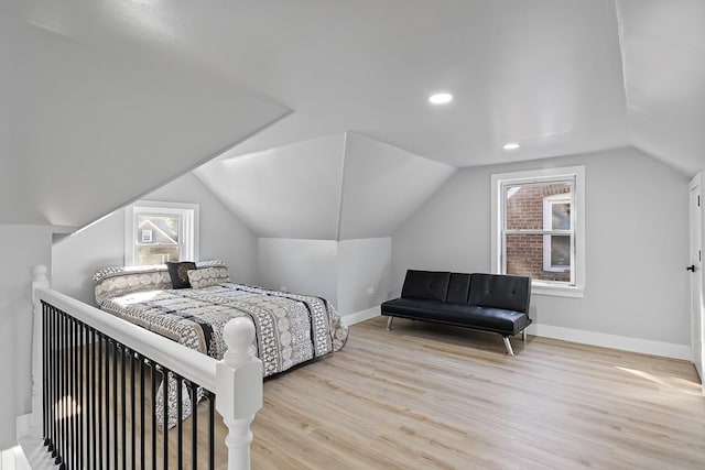 bedroom featuring vaulted ceiling and light wood-type flooring