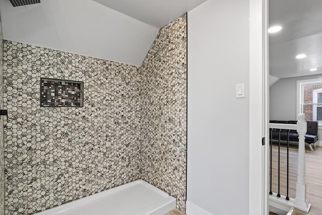 bathroom featuring vaulted ceiling and hardwood / wood-style floors