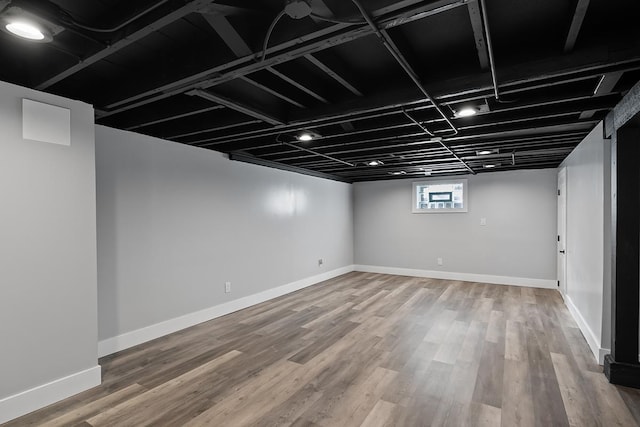 basement with hardwood / wood-style floors