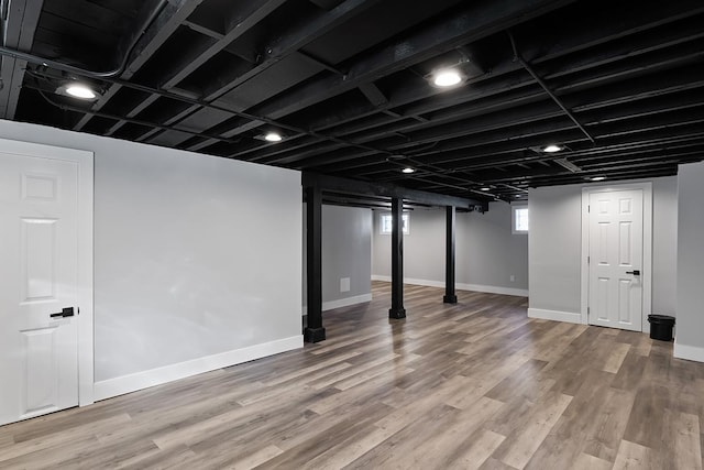 basement with hardwood / wood-style flooring