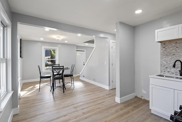 dining area featuring sink and light hardwood / wood-style floors