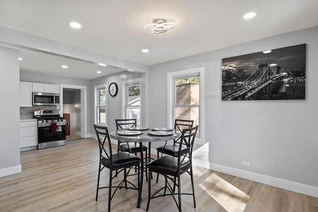 dining space with light hardwood / wood-style floors