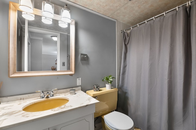 bathroom featuring vanity, toilet, and a shower with shower curtain