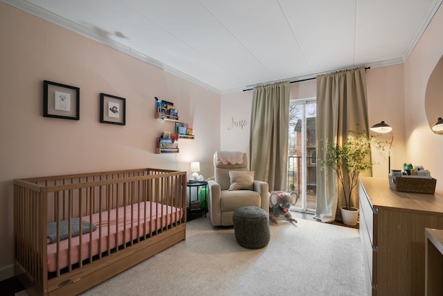 bedroom with ornamental molding and carpet