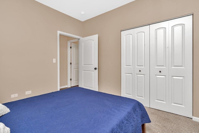 carpeted bedroom with a closet