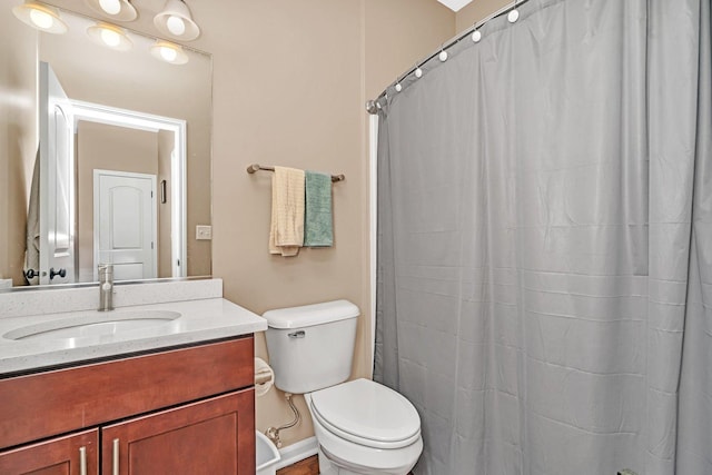 bathroom with vanity, curtained shower, and toilet