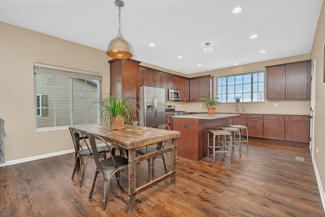 dining area with dark hardwood / wood-style floors and sink