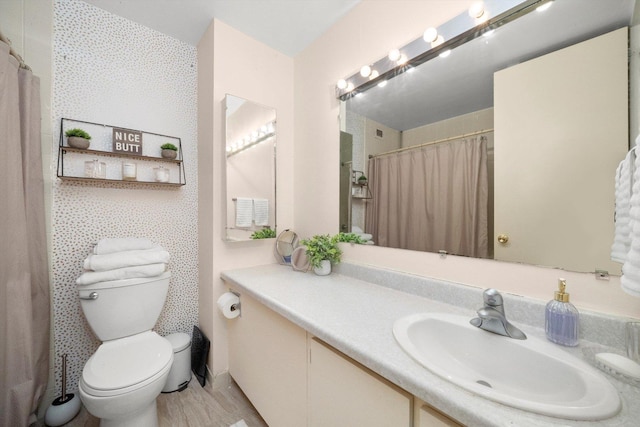 bathroom with vanity and toilet