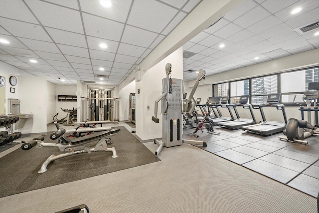 exercise room with a paneled ceiling