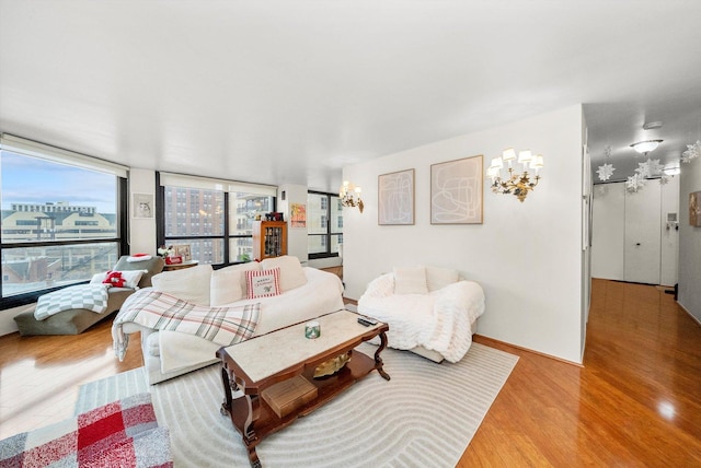 living room featuring hardwood / wood-style floors and a notable chandelier